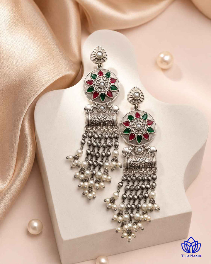 Brass construction forms the structure of this teardrop earring shape.