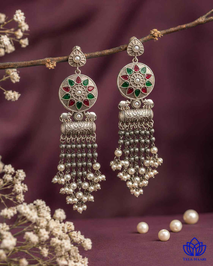 Glass bead detailing adds texture to the red and green design.