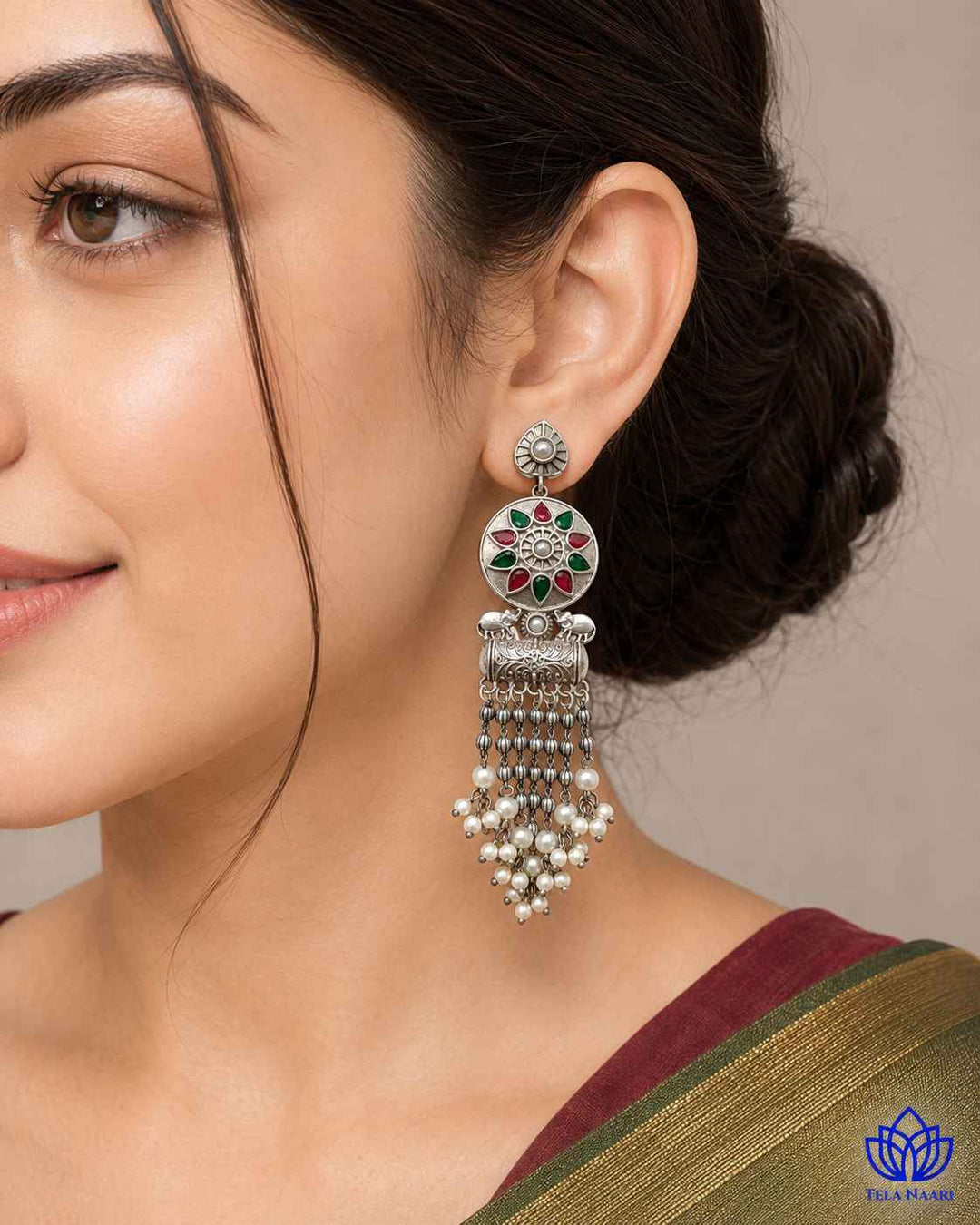 Teardrop silhouette combines red and green tones in this earring.