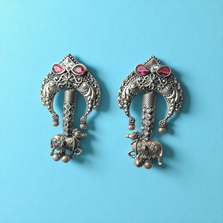 Red accent brings colour to this silver oxidised tusk earring.
