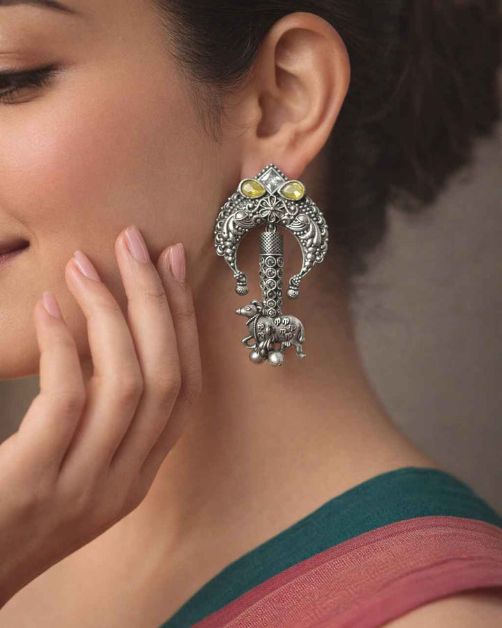 Silver oxidised finish covers the textured surface of this earring.