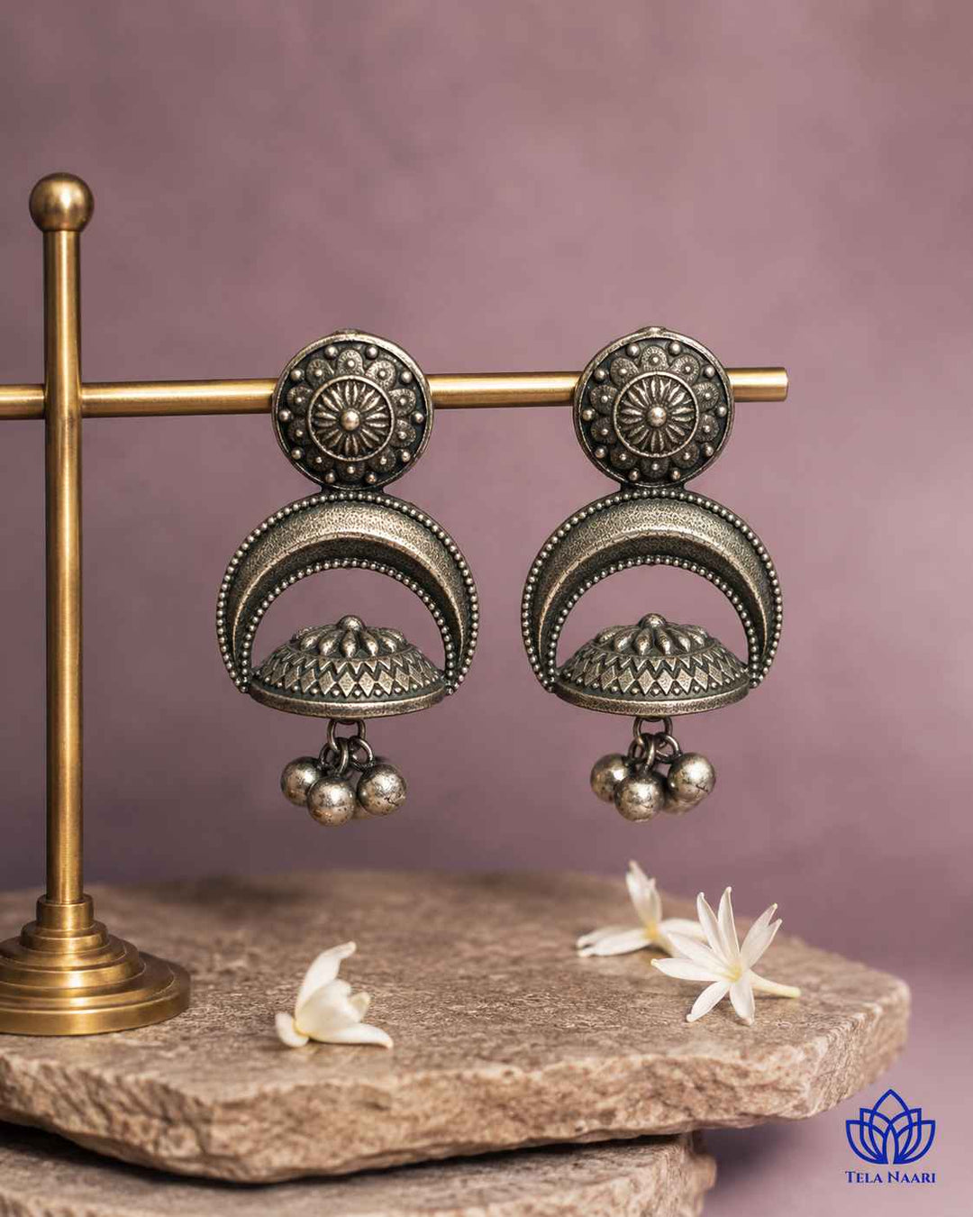 Dome-shaped earring showcases oxidised detailing across its surface.