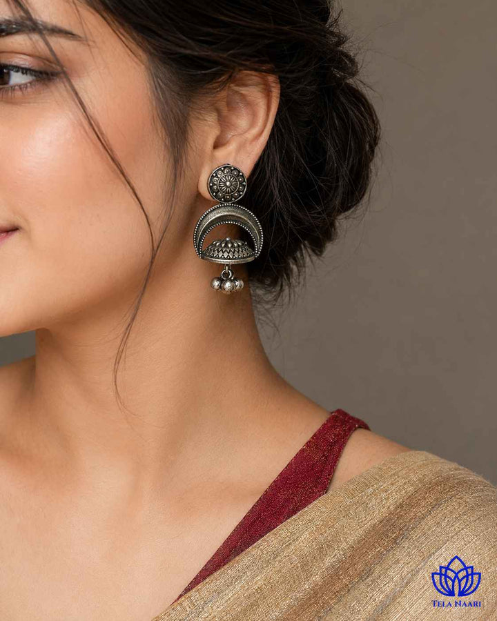 Floral detailing decorates the surface of this dome-shaped earring.