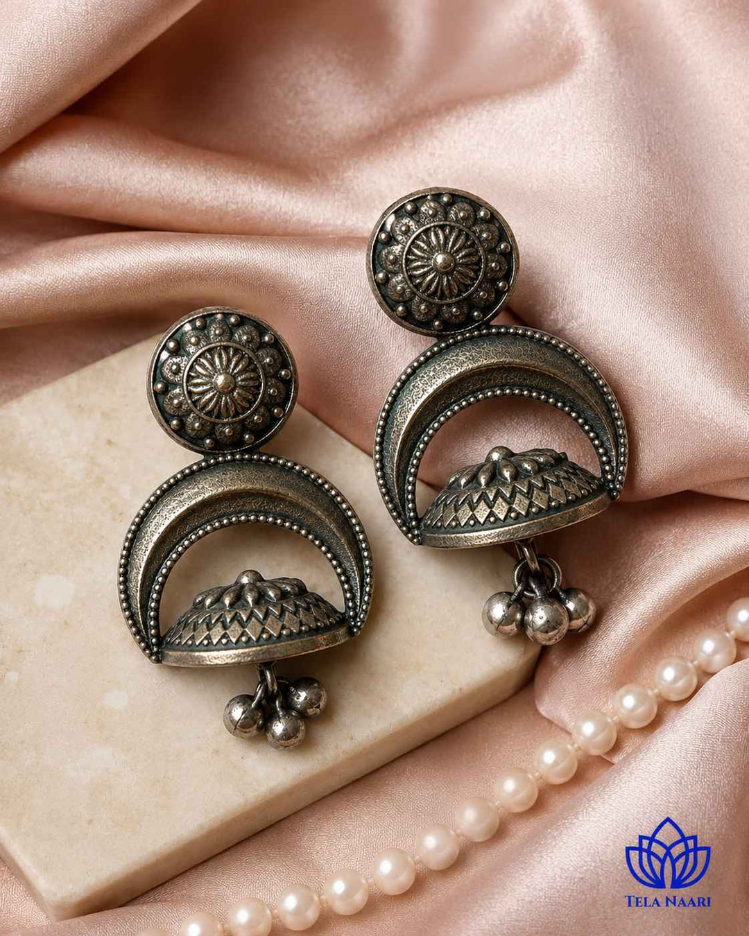 Intricate craftsmanship brings texture to this oxidised earring.