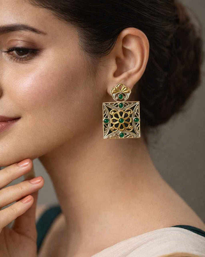 Dual-tone plating covers the bold surface of this square earring.