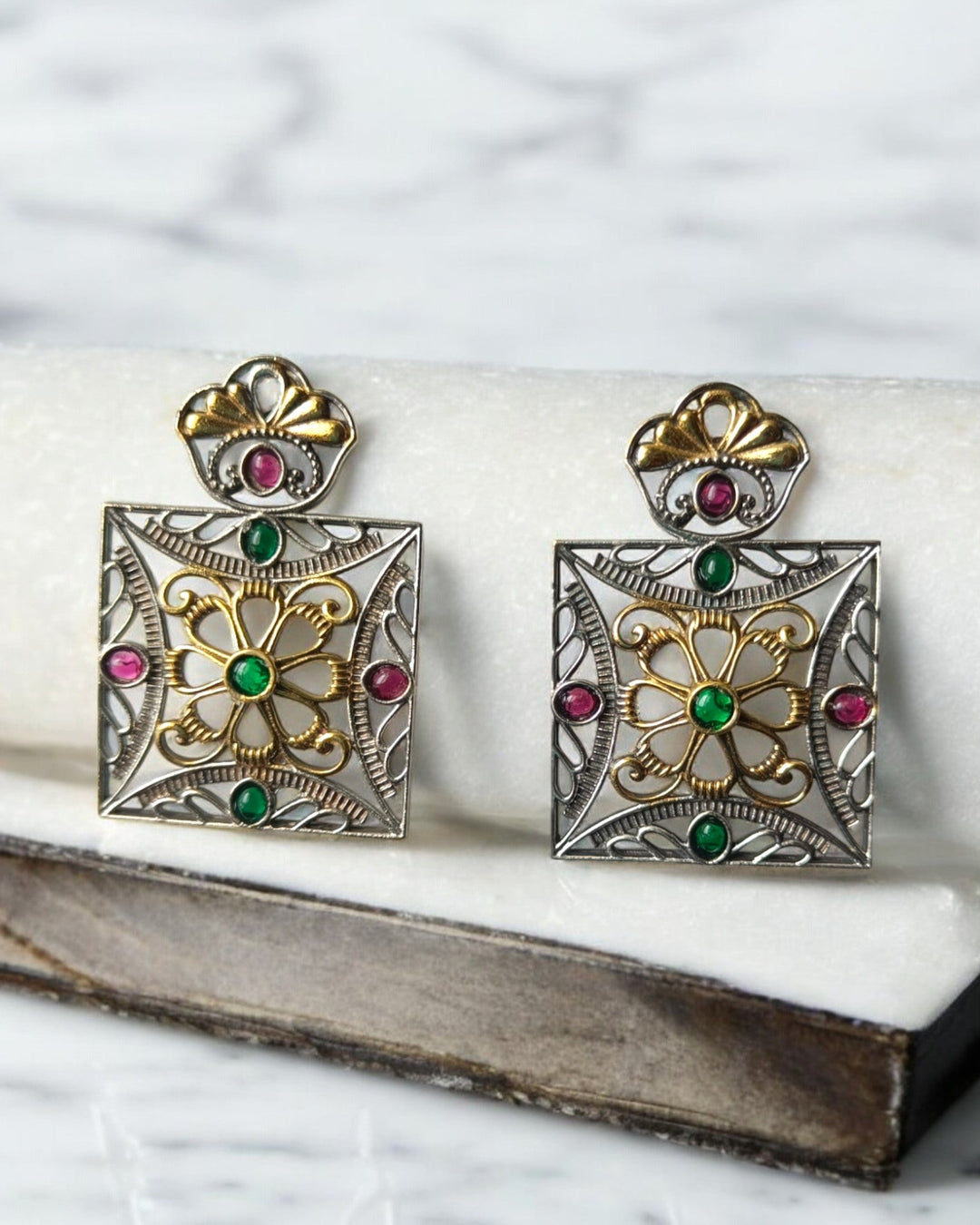 Contemporary silhouette combines dual-tone plating with square geometry.