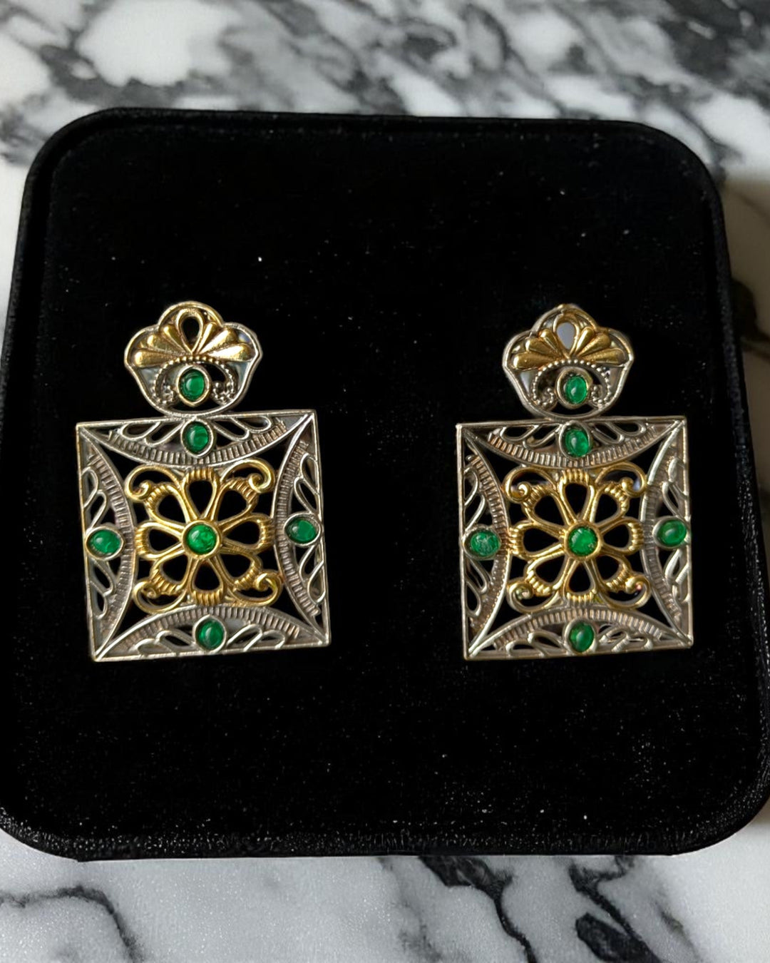 Push-back closure secures this dual-tone square earring in place.