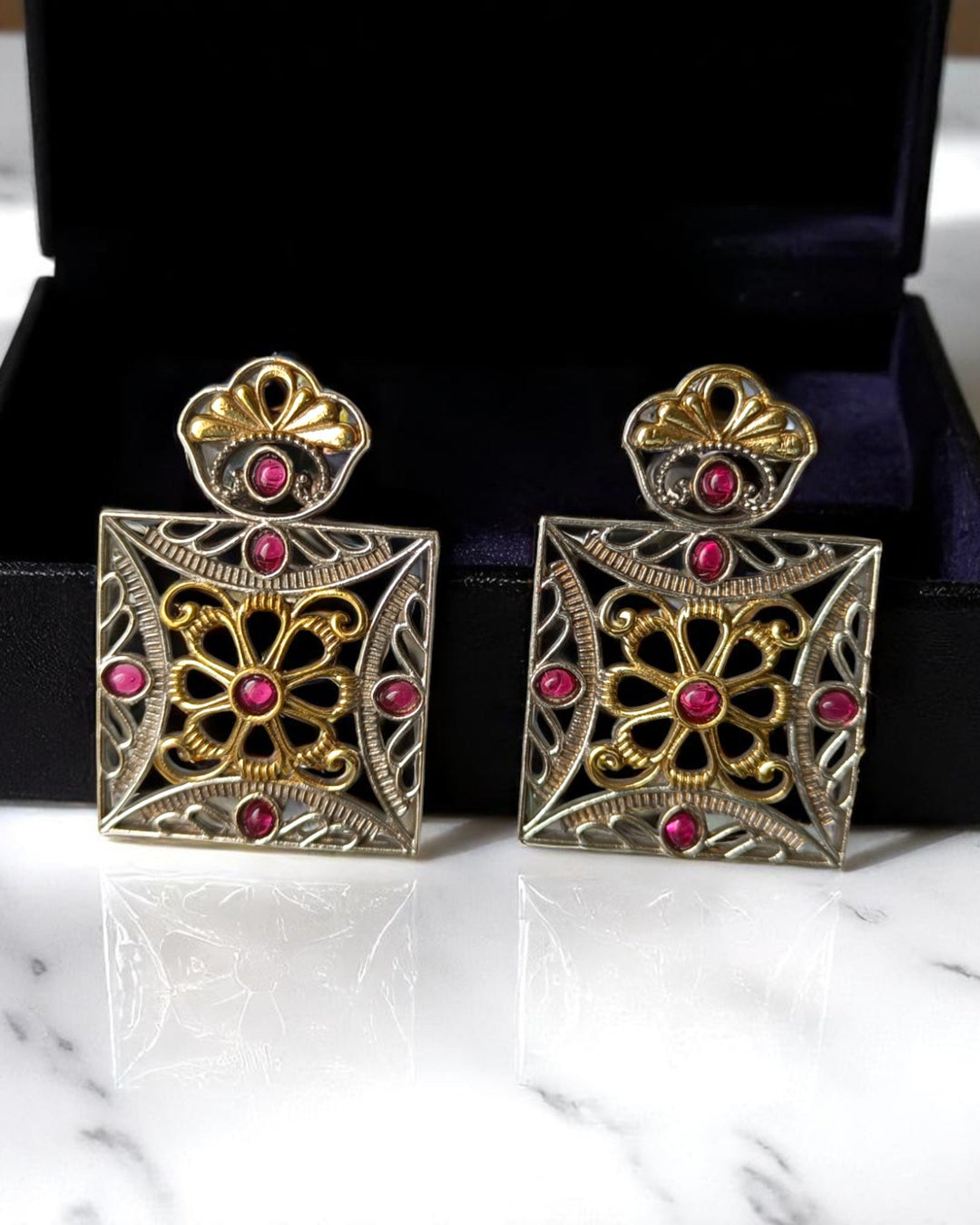 Square silhouette anchors the geometric design of this earring.