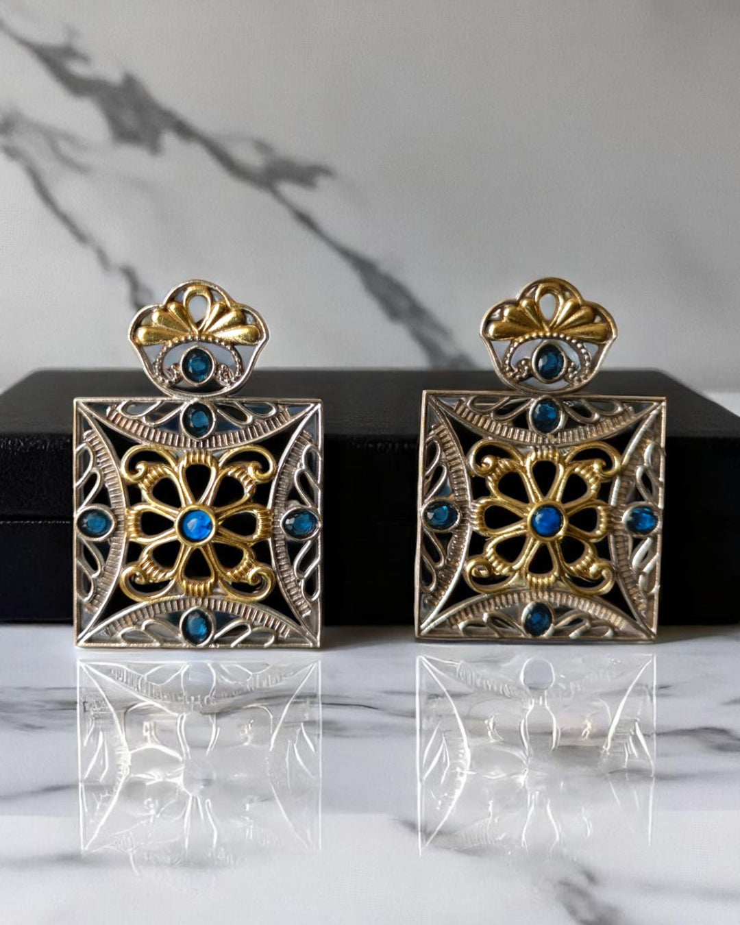 Geometric detailing shapes the square silhouette of this earring.