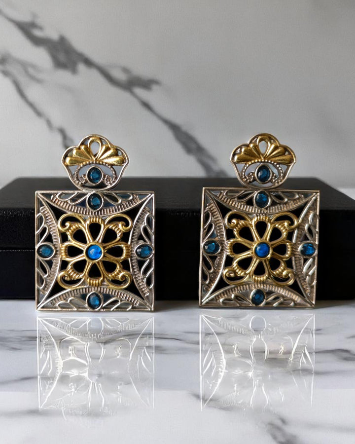 Geometric detailing shapes the square silhouette of this earring.