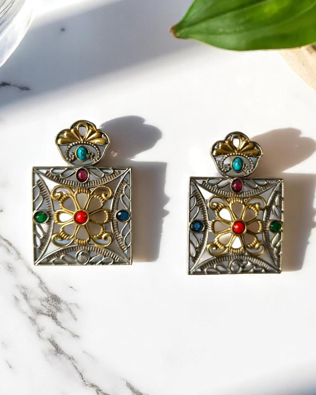 Bold square design pairs brass with vibrant dual-tone plating.