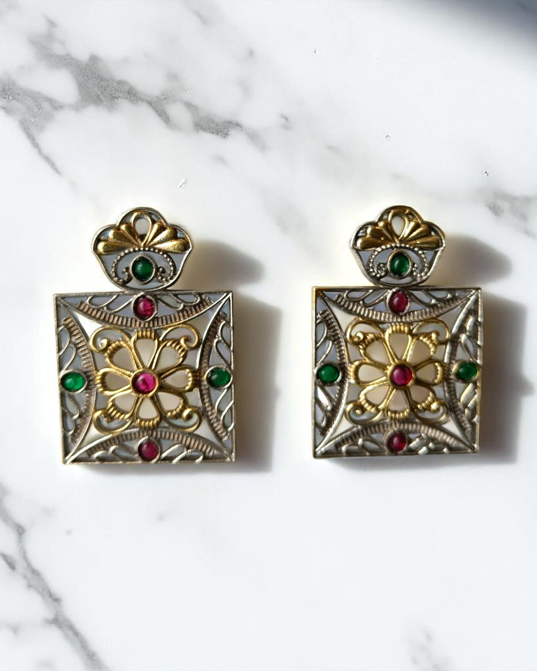 Brass construction supports the geometric structure of this earring.