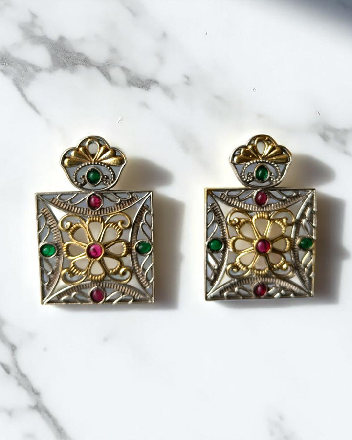 Brass construction supports the geometric structure of this earring.