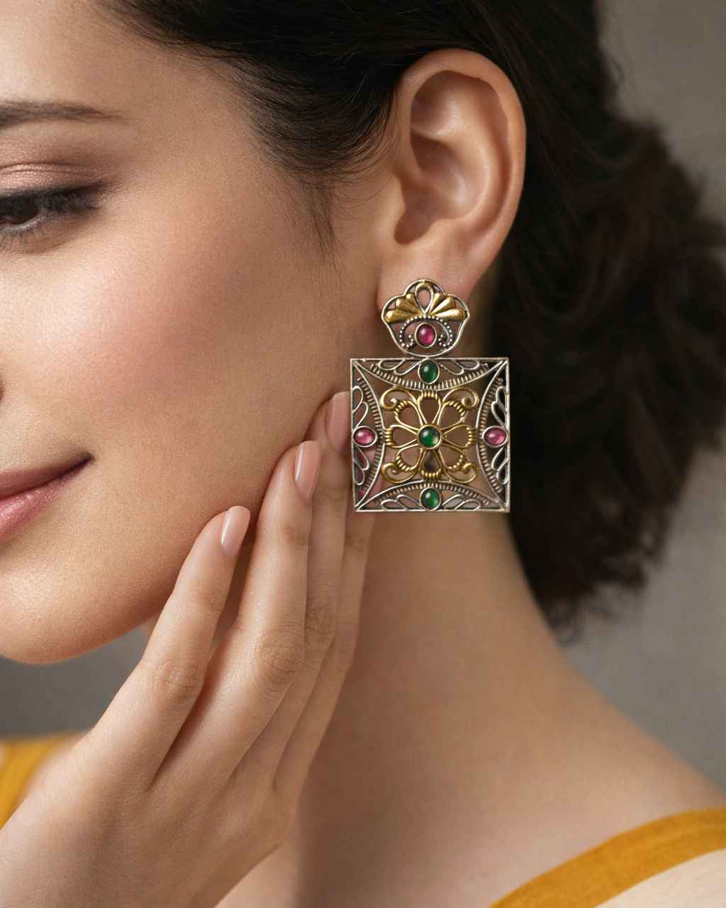 Sharp geometric edges outline the square design of this earring.