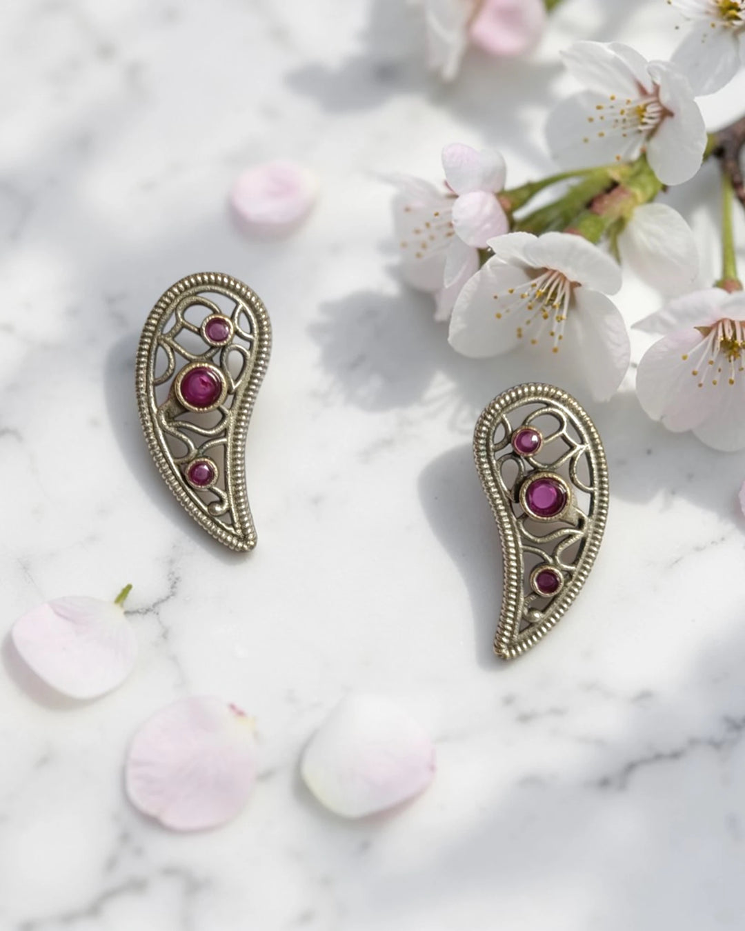 Brass construction supports the lightweight leaf design of this earring.