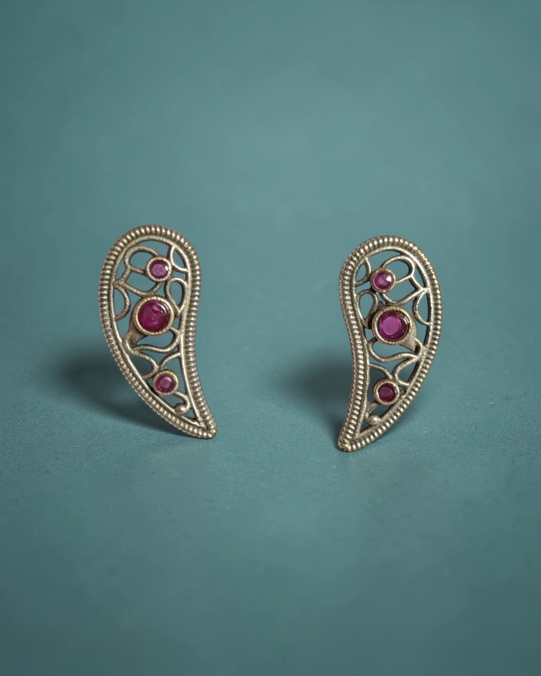 Delicate leaf motif pairs brass with a silver-plated finish.