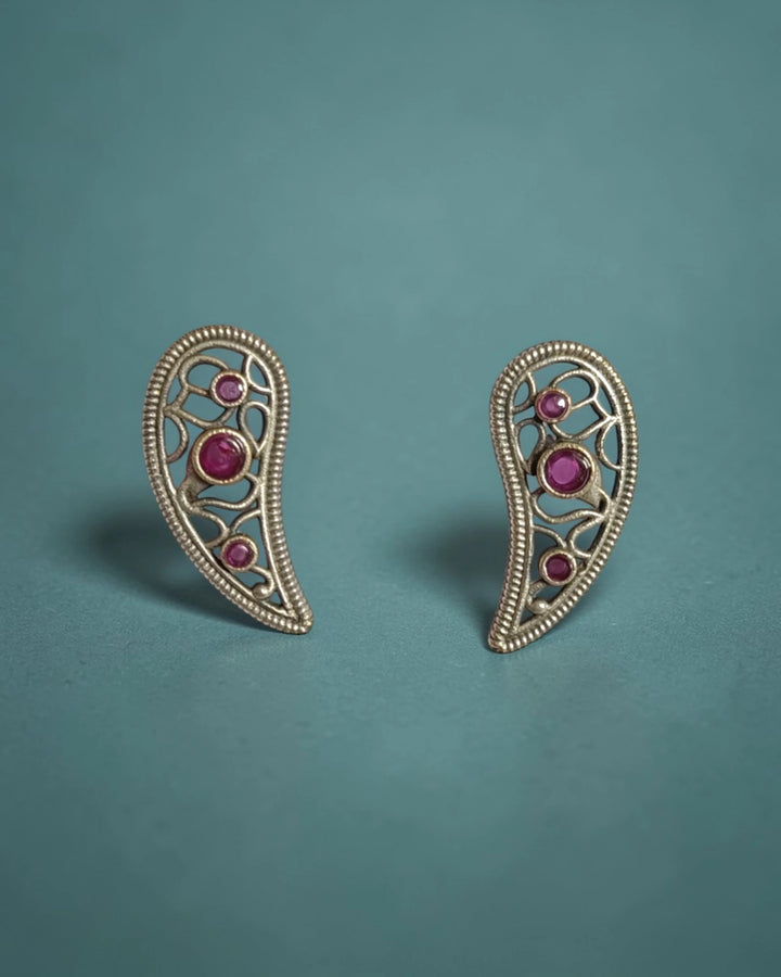 Delicate leaf motif pairs brass with a silver-plated finish.