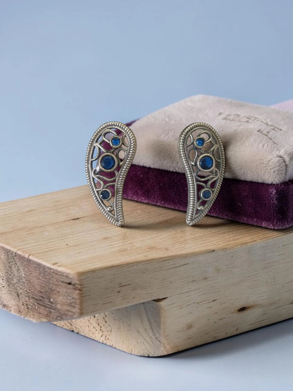 Silver-plated finish covers the delicate leaf shape of this earring.