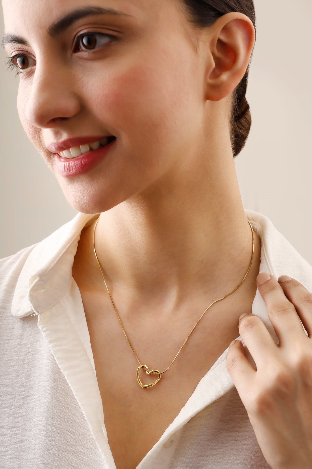 Delicate pendant design pairs an open heart shape with a tarnish-free chain.