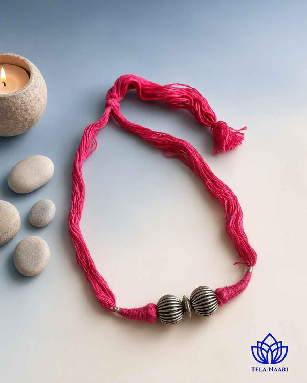 Polished silver-plated thread detailing shapes this choker necklace.