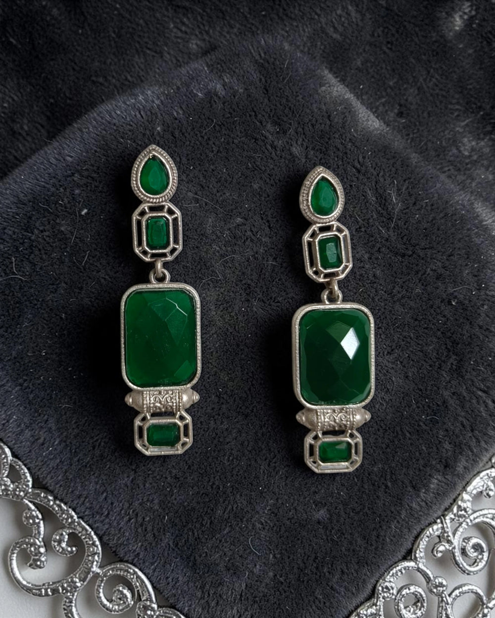Brass construction supports the architectural design of this earring.