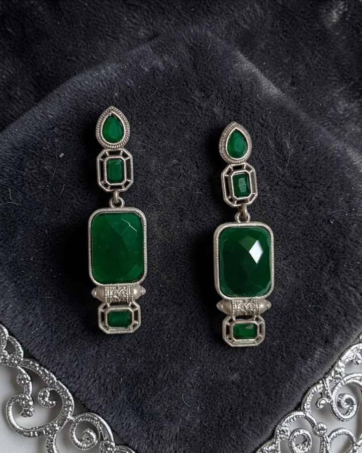 Brass construction supports the architectural design of this earring.