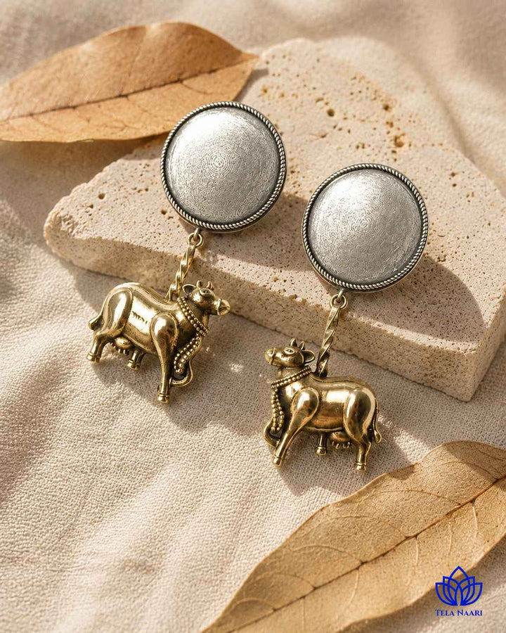 Nandi-inspired cow motif brings whimsical charm to this dual-tone earring.