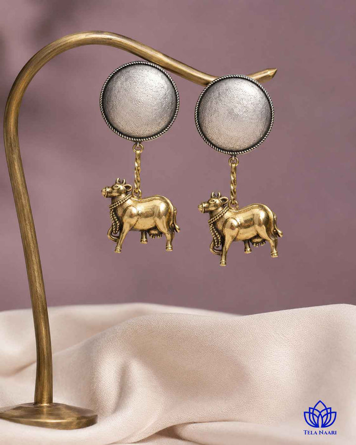 Layered plating creates depth across this dual-tone earring surface.