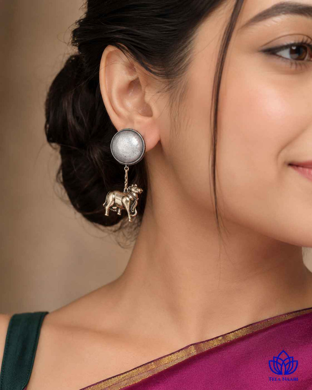 Stone and glass bead detailing decorate this cow-motif earring design.