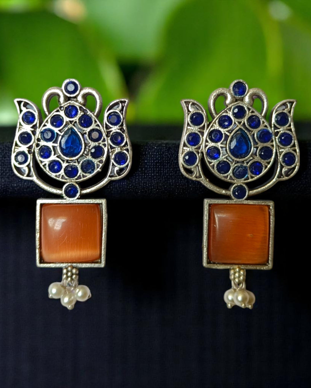Brass construction supports the textured oxidised finish of this earring.
