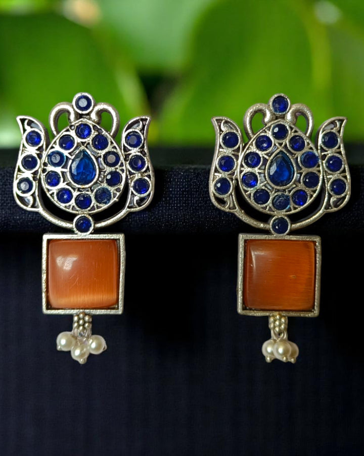 Brass construction supports the textured oxidised finish of this earring.