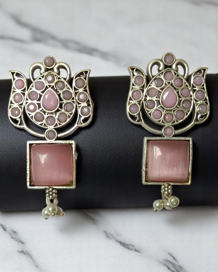 Red accent brings colour to this silver oxidised earring design.