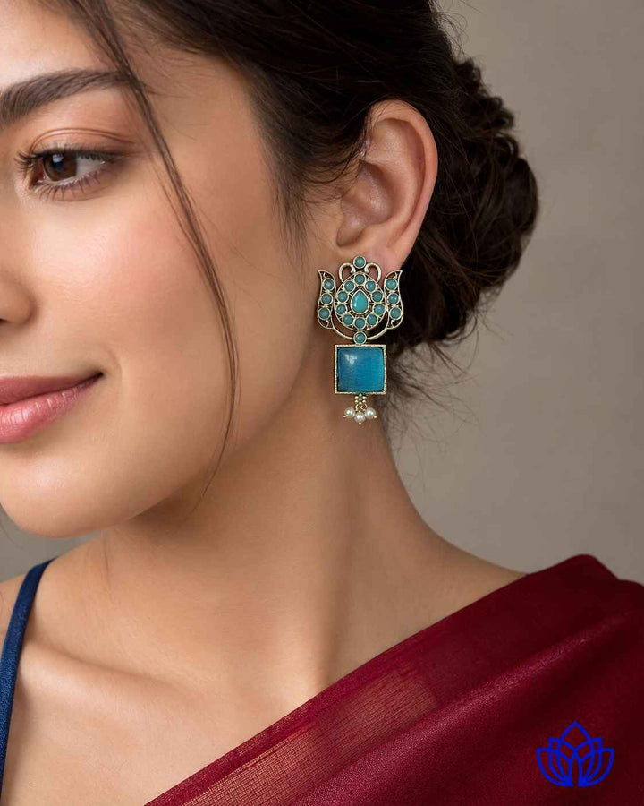 Multicolour detailing brightens the surface of this sky blue earring.