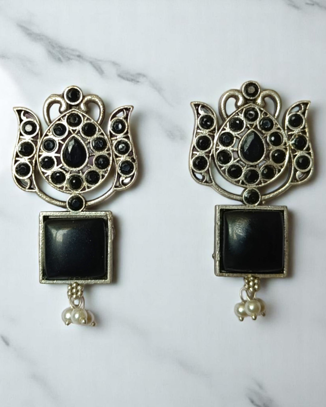 Sky blue tone highlights the oxidised finish of this earring.