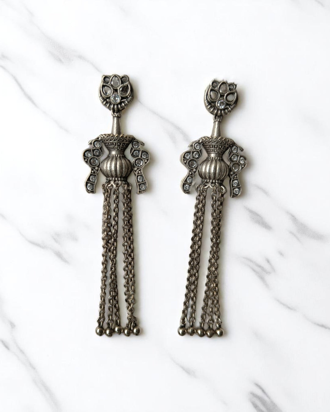 Oxidised brass finish gives these chain earrings their antique texture.