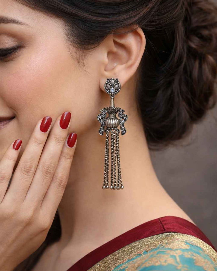 Tribal doll motif anchors this cascading silver oxidised chain earring.