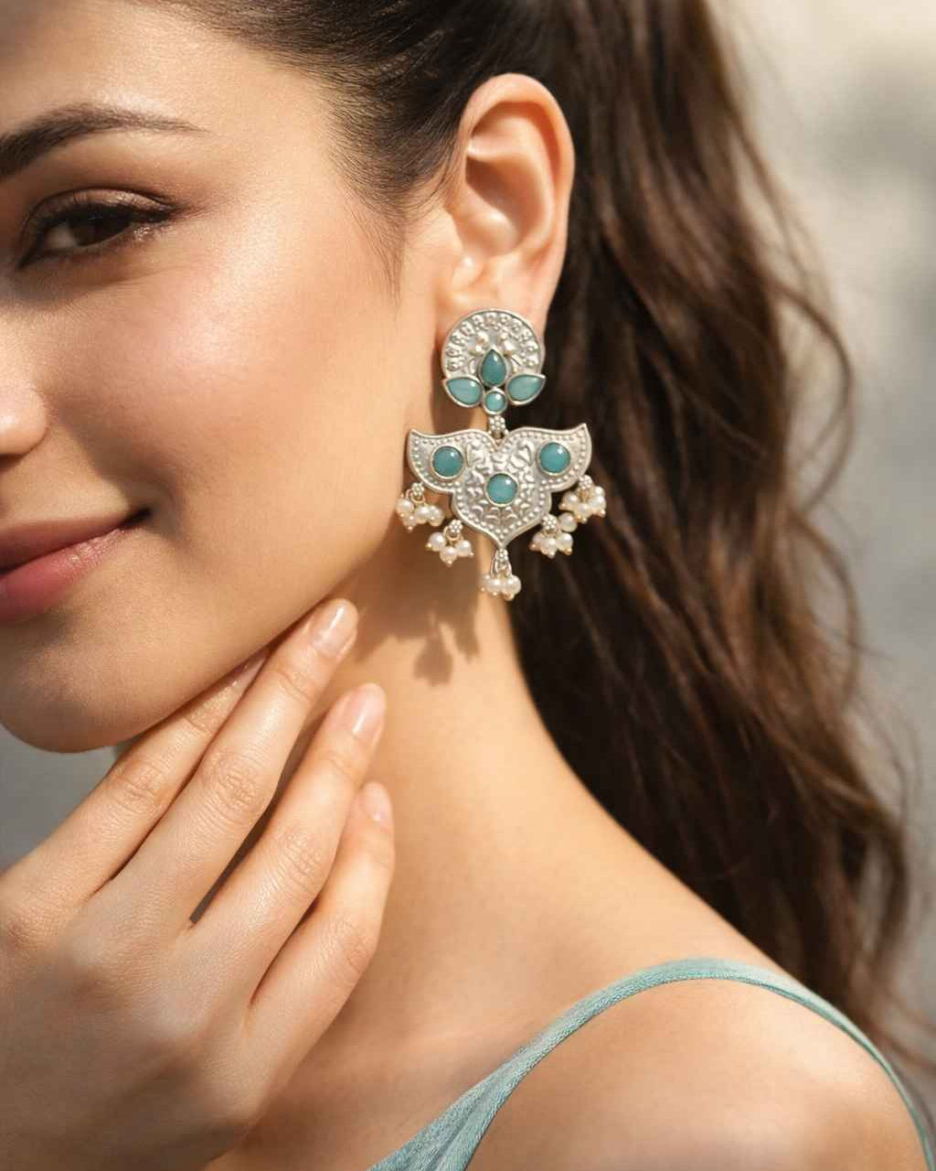 Brass construction supports the intricate oxidised craftsmanship of this earring.