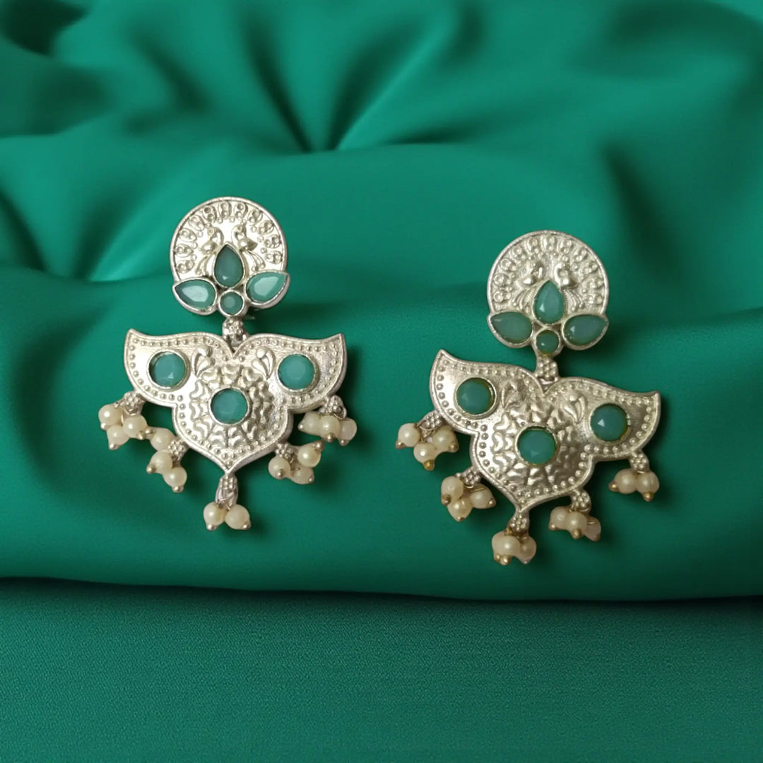 Green accent brings colour to this silver oxidised earring.