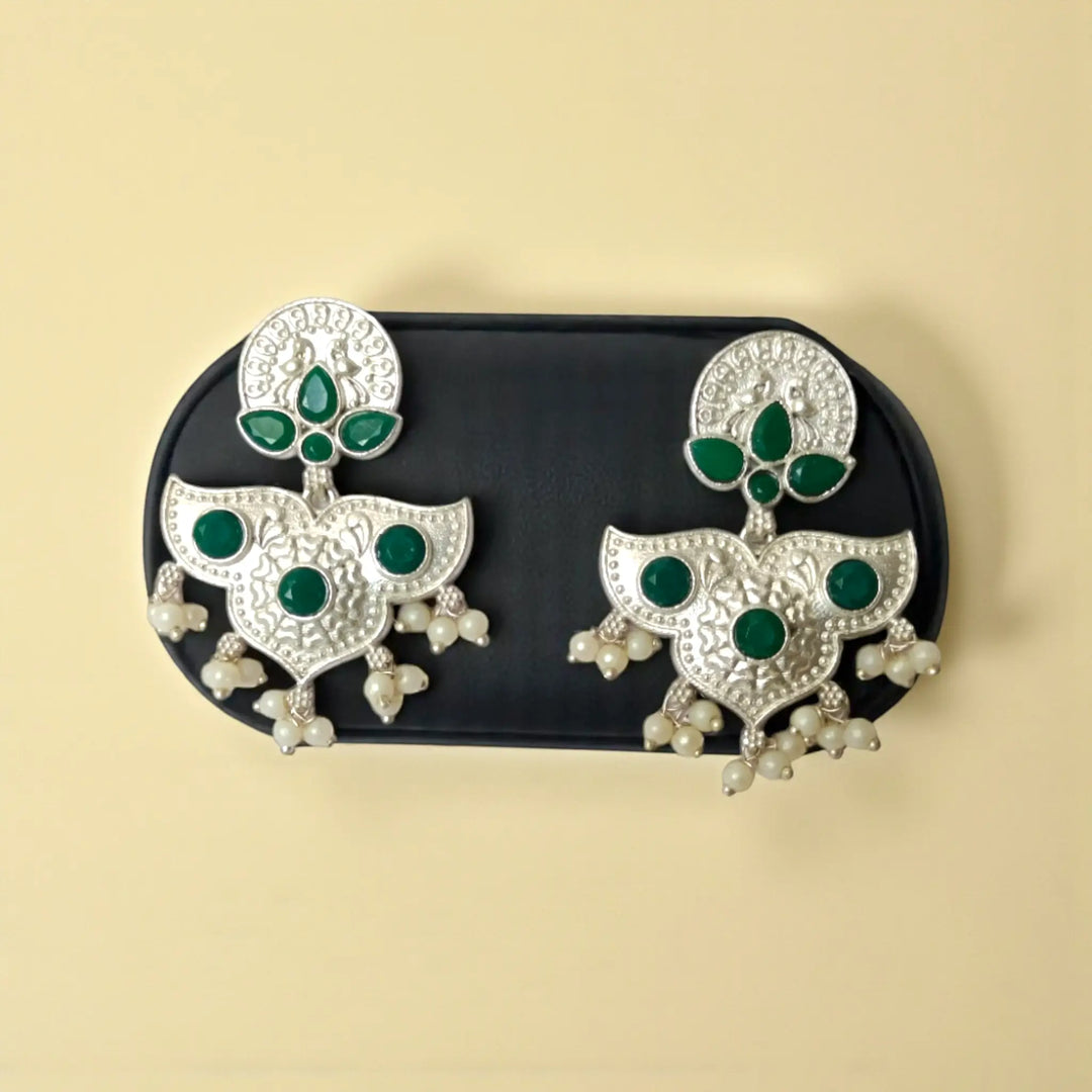 Pink accent brings colour to this silver oxidised earring.