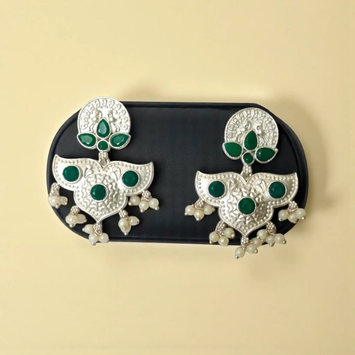 Pink accent brings colour to this silver oxidised earring.