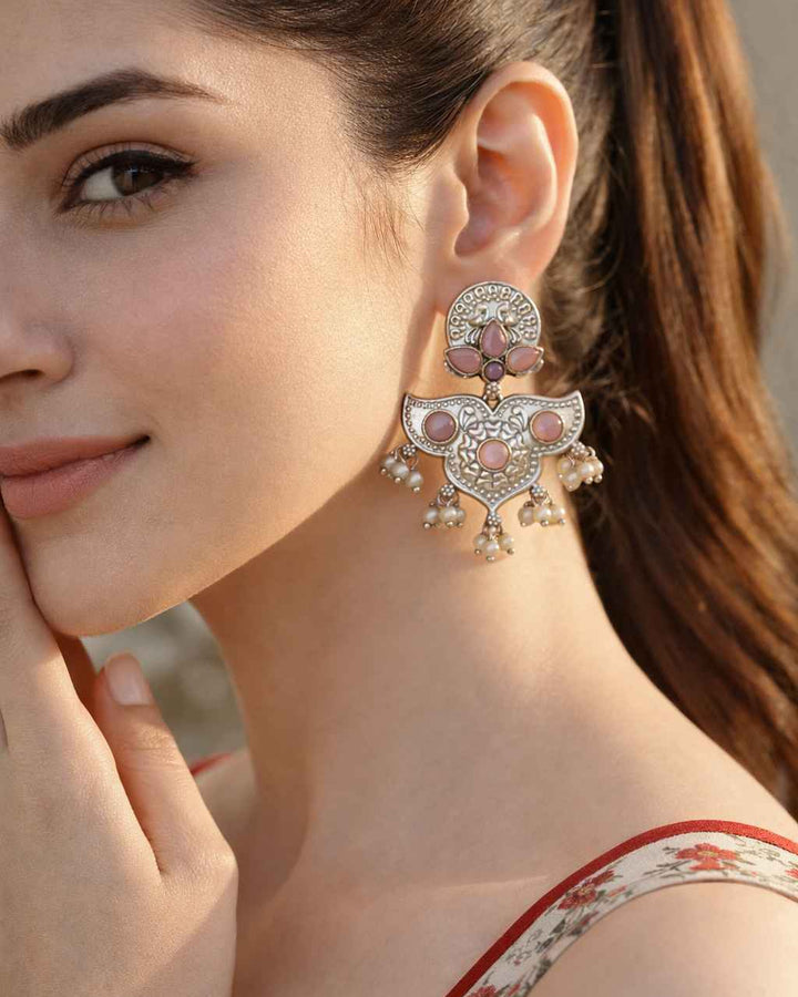 Silver oxidised finish covers the textured surface of this earring.