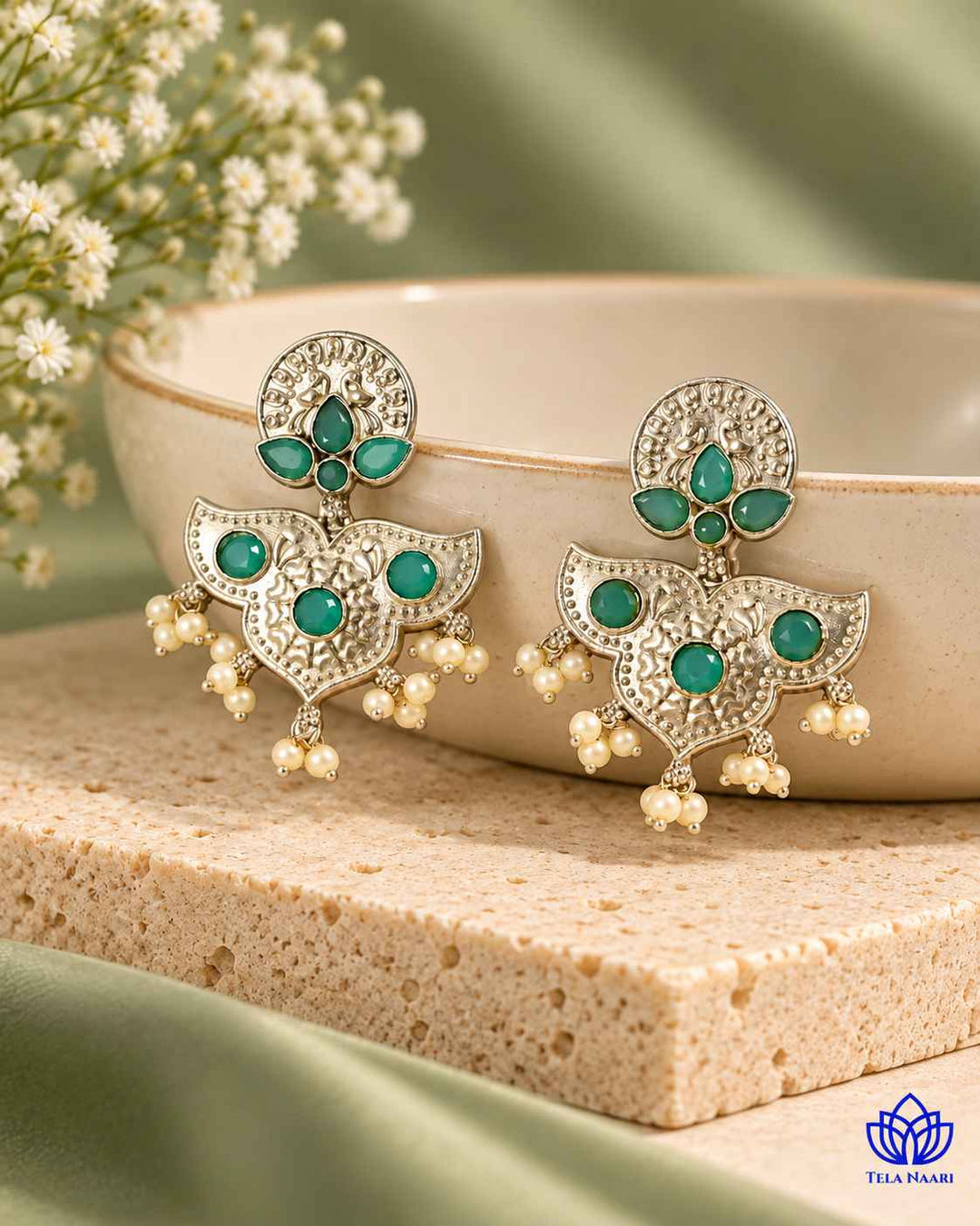 Cool sky blue tones shape the antique silhouette of this earring.