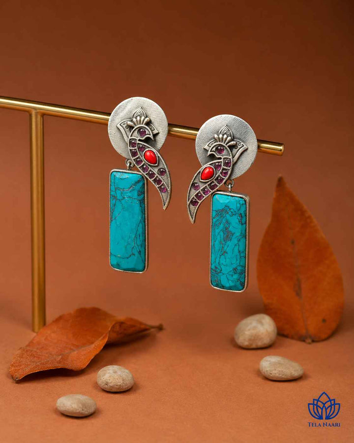 Brass construction supports the handmade design of this earring.