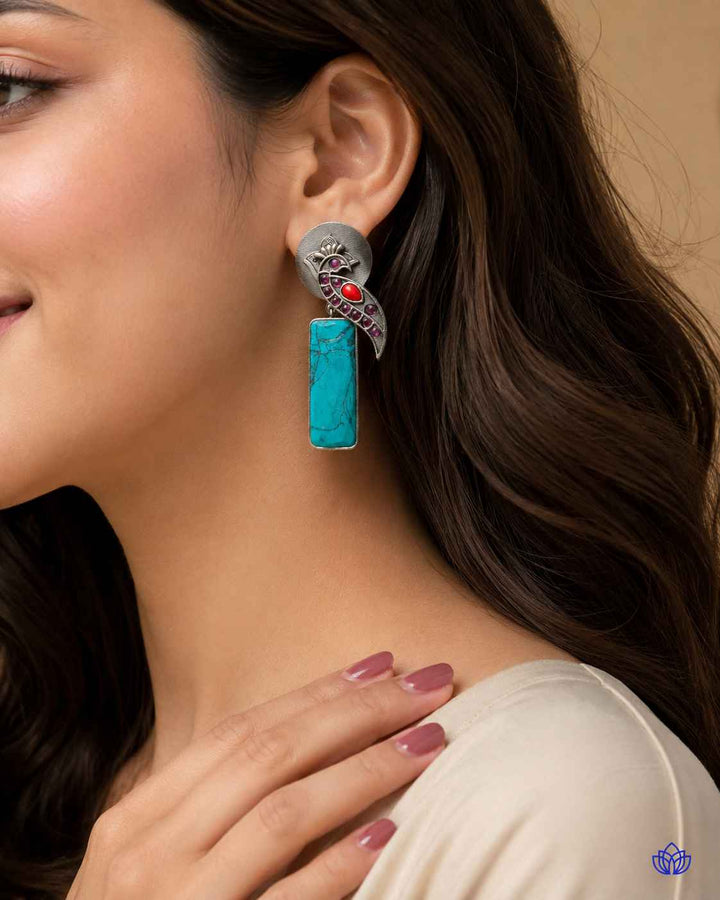 Delicate bead work highlights the intricate design of this earring.