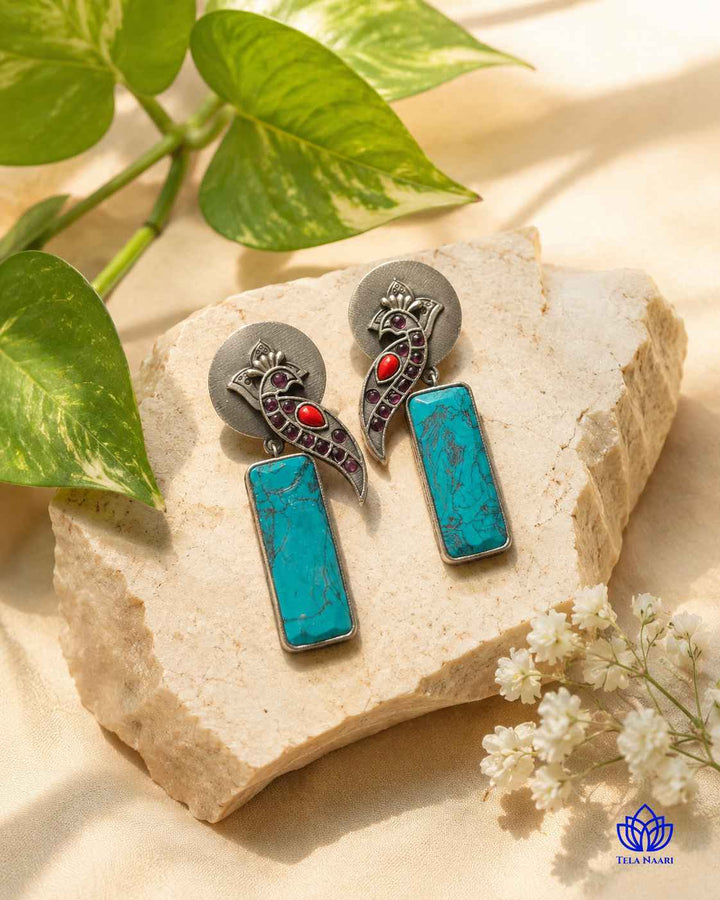 Handmade craftsmanship gives this earring its vibrant, intricate charm.