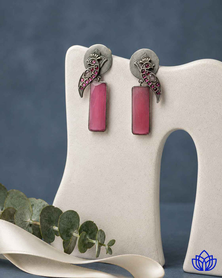 Brass construction supports the handmade design of this earring.