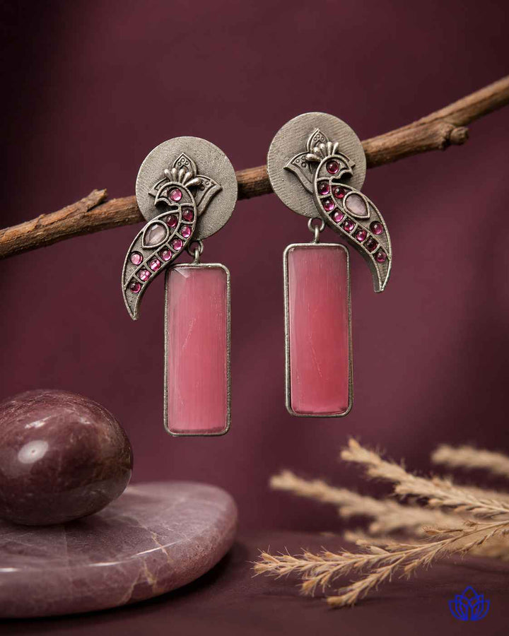 Colourful glass bead detailing decorates the surface of this earring.