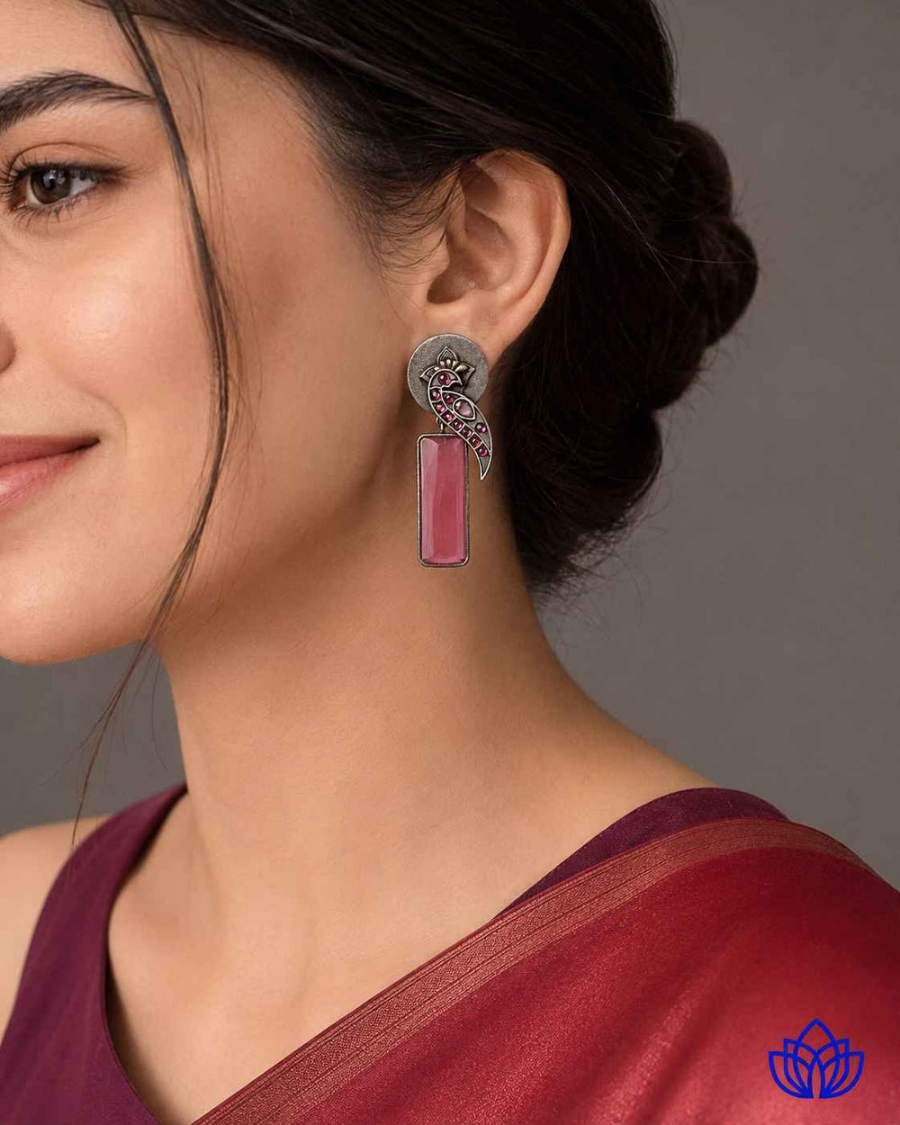 Silver-plated finish covers the surface of this pink earring.