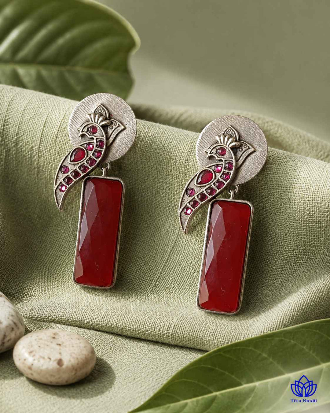 Post and back closure secures this silver-plated red earring.