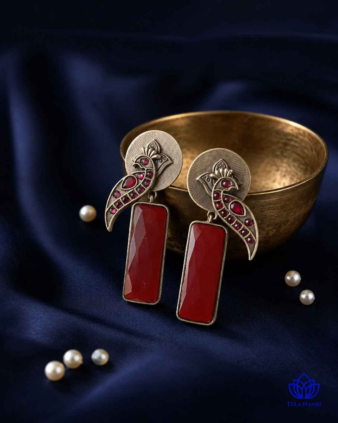 Textured surface combines glass beads with red stone detailing.